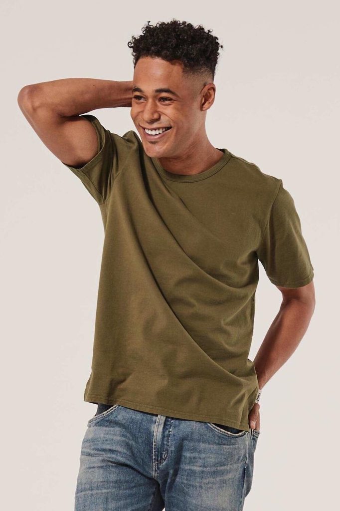 man wearing an organic cotton t-shirt from sustainable mens clothing brand Pact