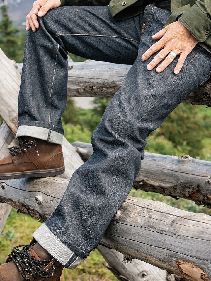 man on a fence wearing American-made denim jeans from ginew