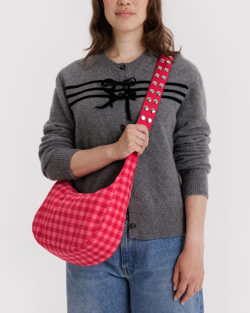 woman wearing a recycled nylon handbag with pink gingham print from affordable sustainable handbag brand baggu