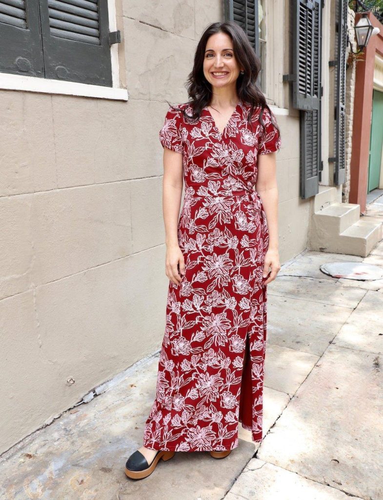 woman wearing a organic red dress with floral print from affordable sustainable clothing brand Passion Lilie