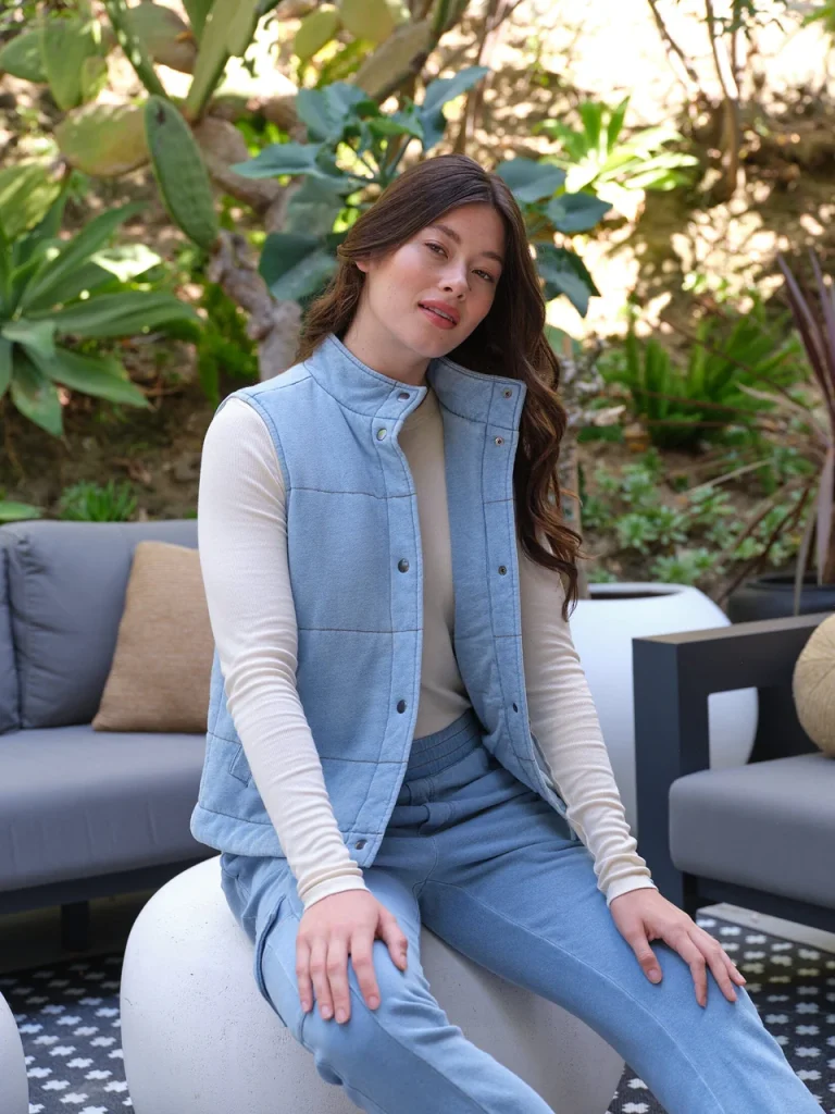 woman wearing an organic denim sweatsuit made from affordable sustainable clothing brands threads for thought