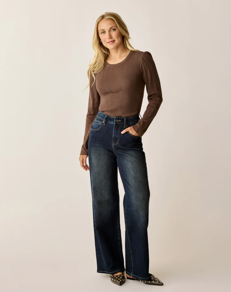 a woman wearing a pair of eco-friendly jeans from sustainable fashion brand carve designs