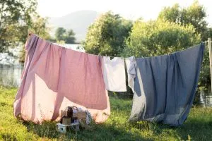 non toxic organic bed sheets hanging on a clothes line