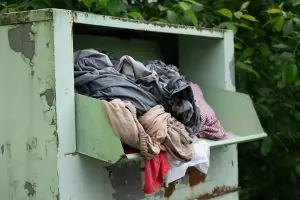a clothing donation box full of clothes that may end up in a landfill