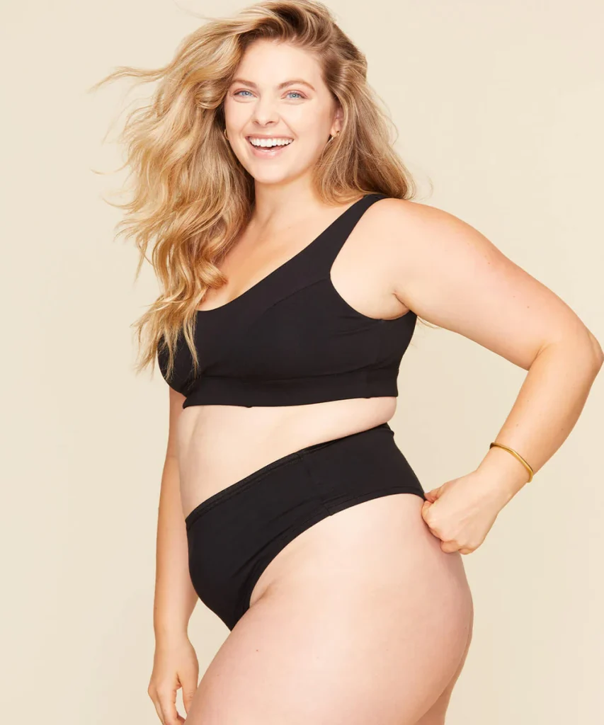 woman wearing a black organic cotton bra and underwear from ethical brand subset