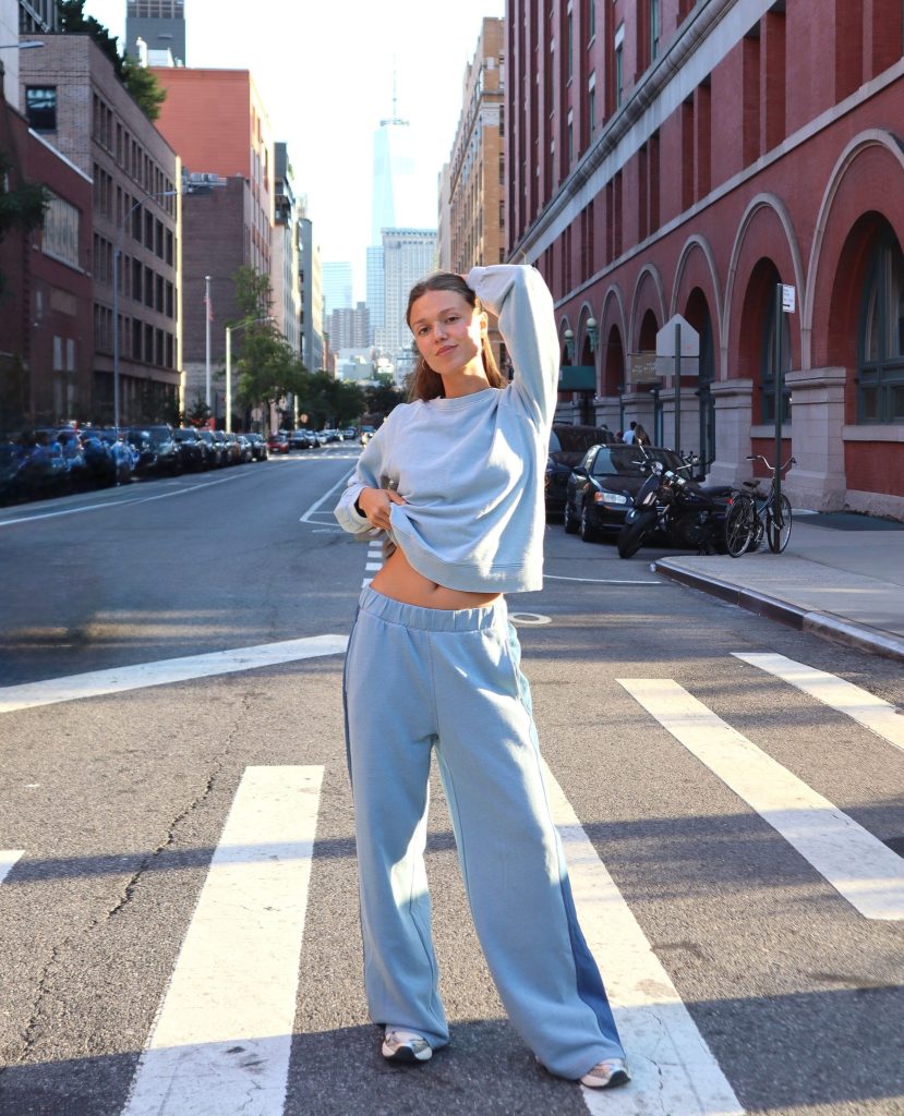a woman in the street wearing a sustainable sweatsuit from ethical brand threads 4 thought