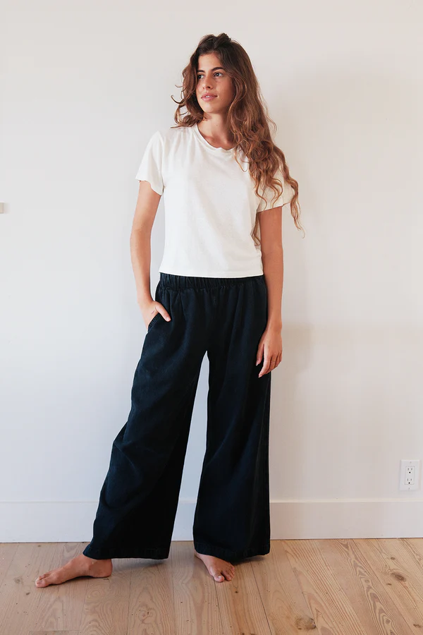 woman wearing wide leg sustainable denim pants made from organic cotton and hemp by ethical brand jungmaven